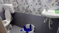 Owner photograph of a tiled bathroom with toilet and wash basin